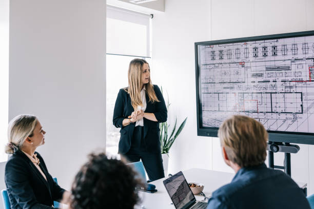 istock Female architect making a presentation for her team 1560251582