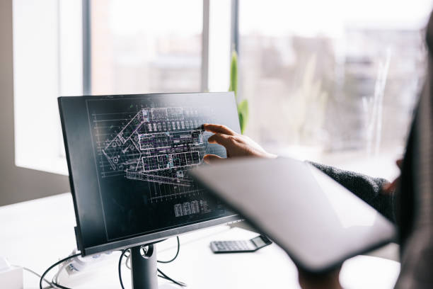 istock Businesswoman working with blueprints on a digital tablet and computer 1560252668
