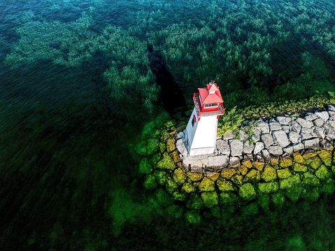 Aerial view of a lighthouse on Lake Simcoe from a drone