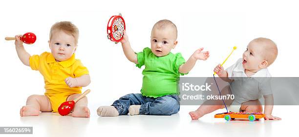 Bebés Jugando Con Juguetes De Musical Foto de stock y más banco de imágenes de Bebé - Bebé, Música, Juguetón