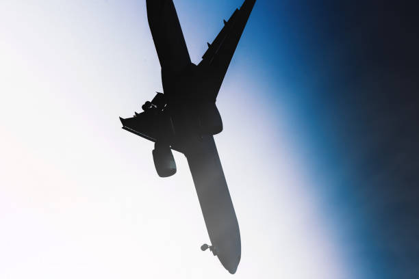 istock Silhouette of a large airplane crashing 1560273126