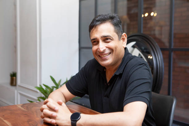 istock Cheerful mature man sitting at a table 1560274242