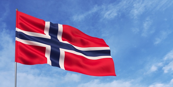 Norway flag on flagpole on blue sky background. Norwegian flag fluttering in the wind against a sky with white clouds. Place for text. 3d illustration.