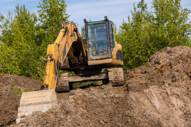 istock Yellow excavator works on a pile of soil 1560323604