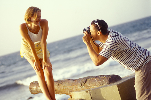 Man taking picture of his girlfriend on the beach, Choroní, Venezuela