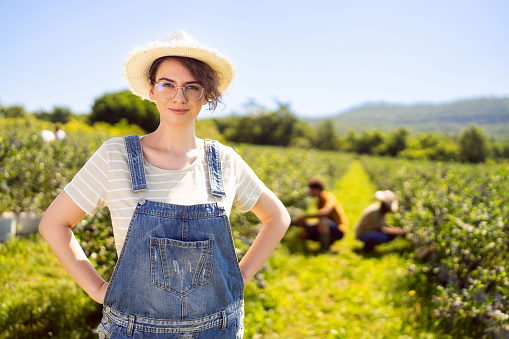Portrait of young Caucasian woman at the organic blueberry farm