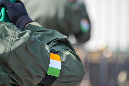A man in paramilitary uniform, with an armband showing an Irish tricolour as he commemorates the Easter Rising of 1916