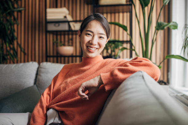 istock Woman sitting at home 1560340617