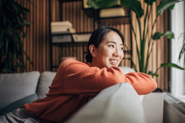 istock Woman sitting at home 1560341192