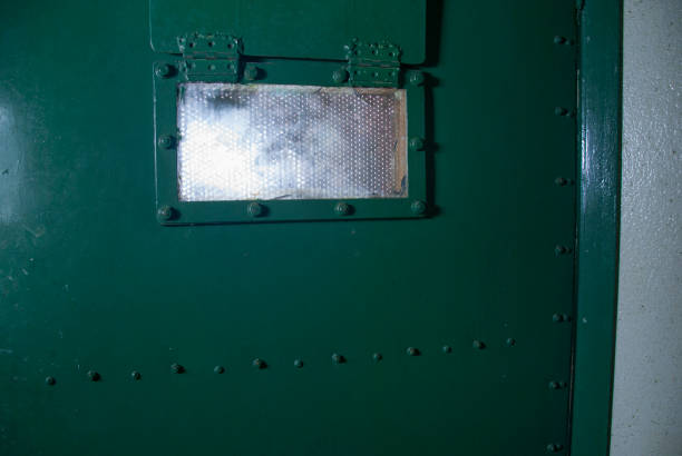 Window on a green prison door