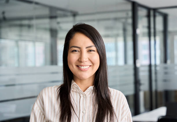 Confident smiling young Asian business woman in office, headshot portrait. Confident smiling young professional Asian business woman corporate leader, happy japanese female employee, company sales marketing manager, standing in office, headshot portrait. headshot stock pictures, royalty-free photos & images