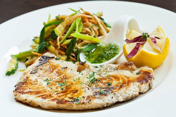 A swordfish filet with steamed vegetables and spices
