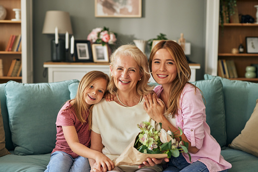 Happy three generation family celebrating grandmothers birthday portrait
