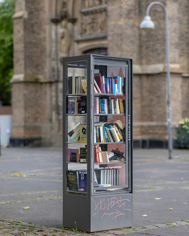 Cologne, Germany - Jul 16th 2023: German cities are full of miniature public libraries. People can pick up and return books here.