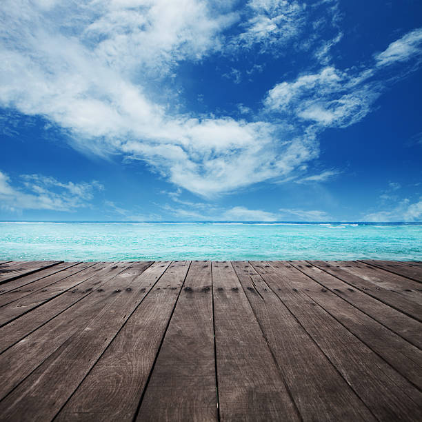 istock Brown wooden platform under cloudy blue sky 156037831