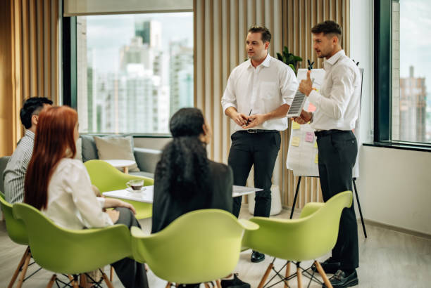 In diverse workspace, project manager presents eco-friendly solar panels, and sustainable solutions