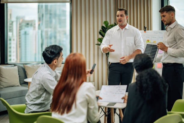 istock In diverse workspace, project manager presents eco-friendly solar panels, and sustainable solutions 1560383790