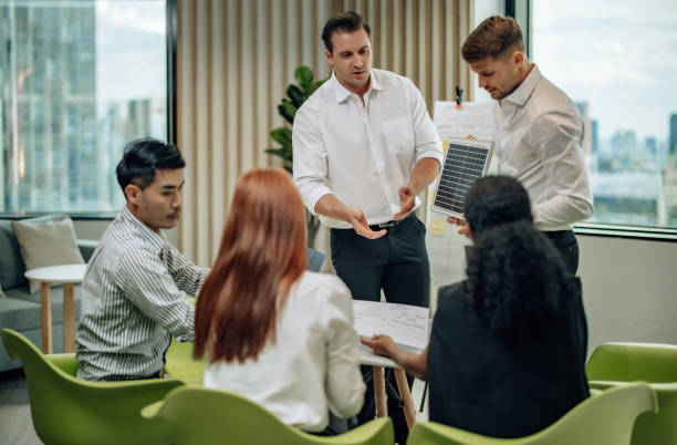 istock In diverse workspace, project manager presents eco-friendly solar panels, and sustainable solutions 1560384880