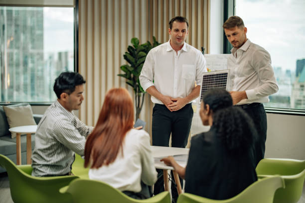 istock In diverse workspace, project manager presents eco-friendly solar panels, and sustainable solutions 1560384882