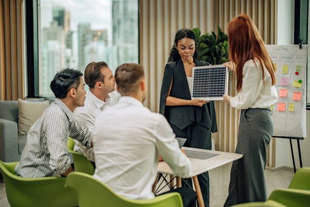 istock In diverse workspace, project manager presents eco-friendly solar panels, and sustainable solutions 1560387131
