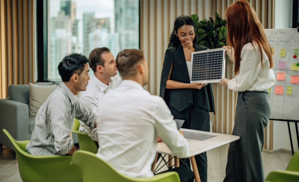 istock In diverse workspace, project manager presents eco-friendly solar panels, and sustainable solutions 1560387135