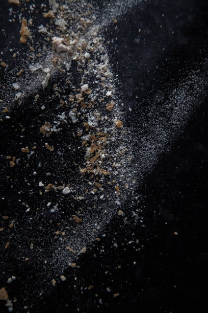 istock Abstract image made with flour and breadcrumbs on dark background. Conceptual image, alluding to space and cosmos, the unknown, light and darkness. 1560392525