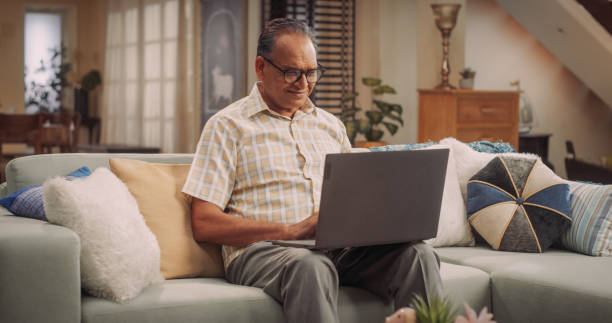 istock Elderly Indian Man Using Laptop at Home: Using Online Forums to Explore Interests, Delving into History, Arts, and Literature. Cultivating Wisdom and Sharing Stories on Social Media. Medium Static 1560457146