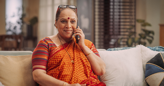Elderly Indian Woman Using Smartphone, Calling Her Friends. Joyful Smiling Senior Lady Talking to Her Family, Daughter, Son, Relatives, Grandchildren. Medium Close-up