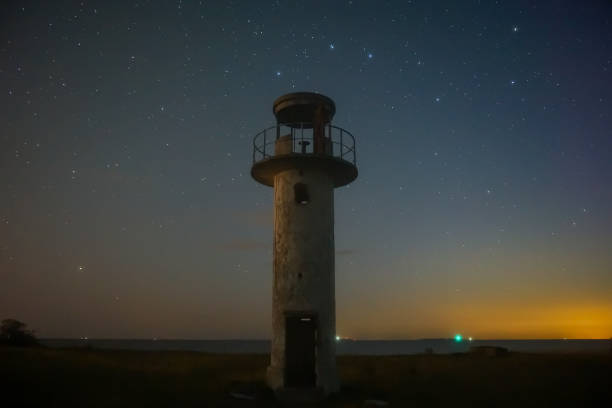 istock Lighthouse at the dark night with starry sky 1560472018