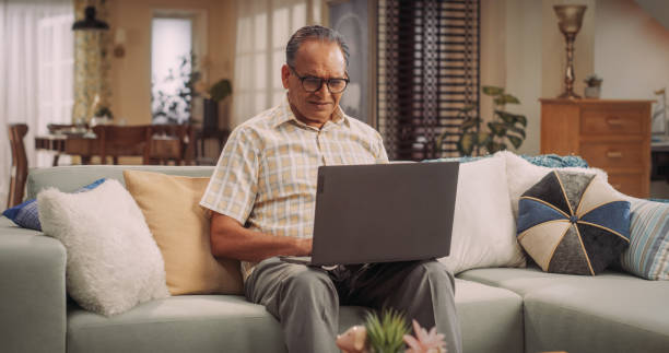 istock Elderly Indian Man Using Laptop at Home: Using Online Forums to Explore Interests, Delving into History, Arts, and Literature. Cultivating Wisdom and Sharing Stories on Social Media. Medium Static 1560473095
