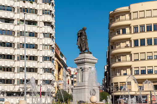 Leon, Spain - November 12 2022: View of Plaza Guzman El Bueno with the fountain and Monument to Guzmán el Bueno, in the city center of Leon. It is a good work by the sculptor Aniceto Marinas, build in 1894.