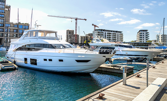 Copenhagen, Denmark - June 28, 2023. View of the pier with moored yachts and boats in Denmark. Yacht parking. A marina lot. Yacht and sailboat is moored at the quay.