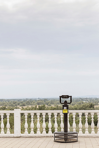 large, public binoculars for observing the surroundings on the Volga River embankment.
