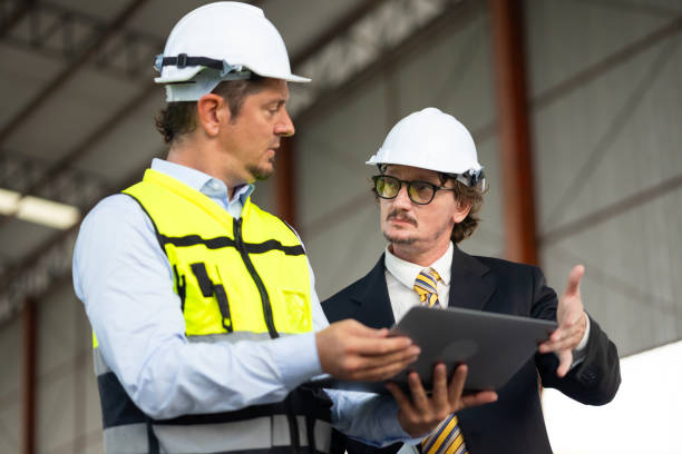 istock Caucasian construction architect Engineering man and busines owner in safety hardhat working at precast factory industrial. Heavy Industry Manufacturing Factory. Prefabricated concrete walls 1560516461