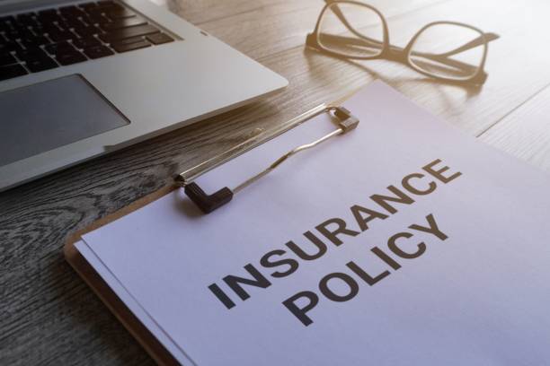 istock Paper clipboard with text INSURANCE POLICY. 1560517568