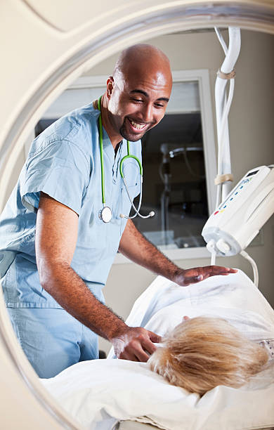 istock Healthcare worker preparing patient for CT scan 156051878
