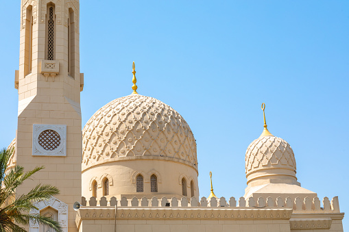 Dubai, United Arab Emirates - June 21, 2023: Closeup of Jumeirah Mosque domes in Dubai city during a day