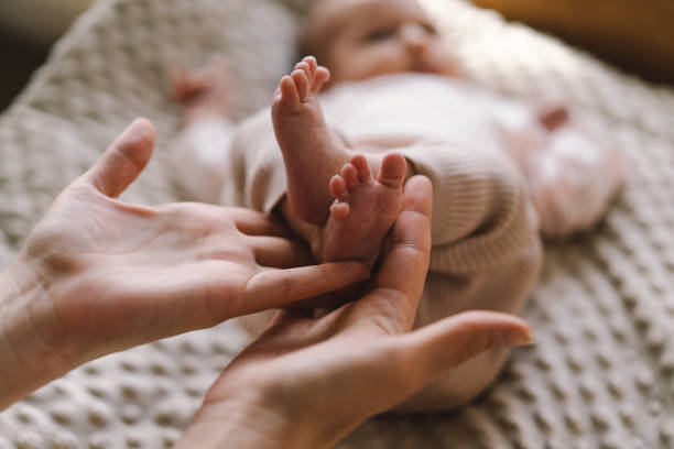 istock Mum making baby massage 1560529465