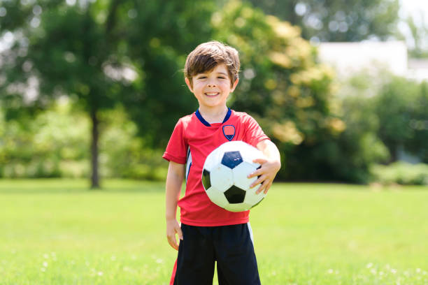 istock Young soccer player having fun on a field with ball 1560529478