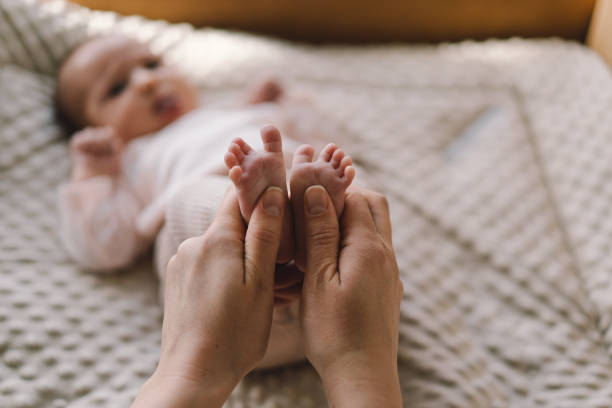 istock Mum making baby massage 1560530371