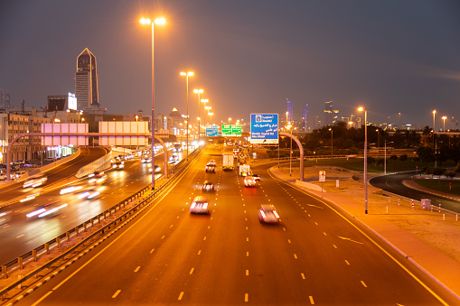 Dubai, United Arab Emirates - June 21, 2023: Dubai highway at night with cars and illuminated buildings