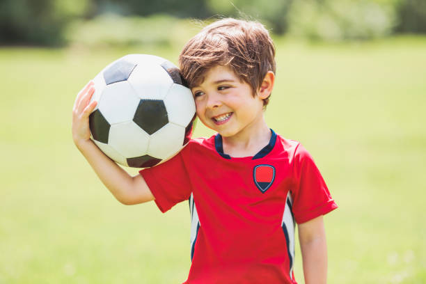 istock Young soccer player having fun on a field with ball 1560531122