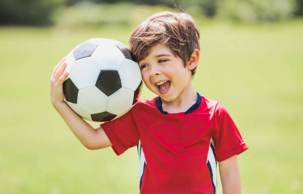 istock Young soccer player having fun on a field with ball 1560531124