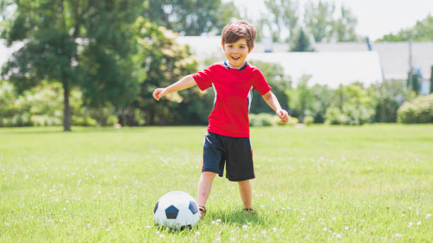 istock Young soccer player having fun on a field with ball 1560531656