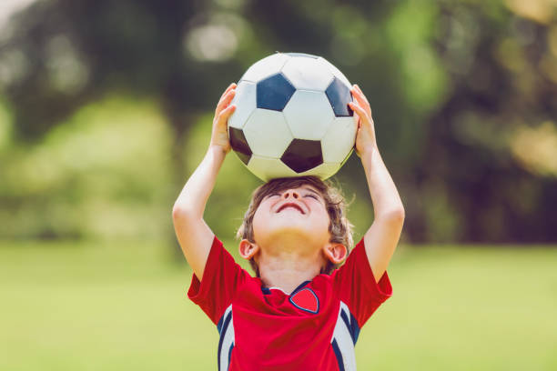 istock Young soccer player having fun on a field with ball 1560531666