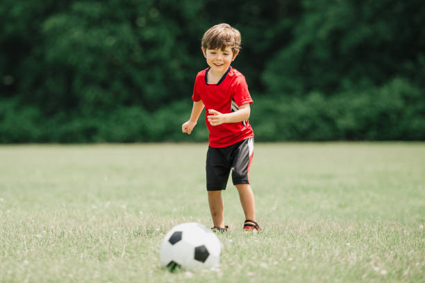 istock Young soccer player having fun on a field with ball 1560531710