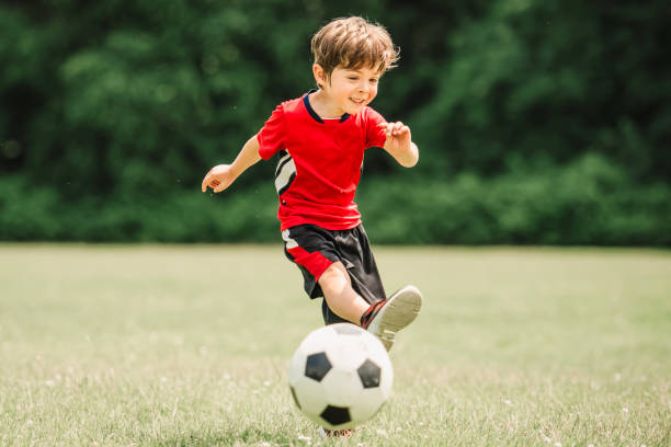 istock Young soccer player having fun on a field with ball 1560531897