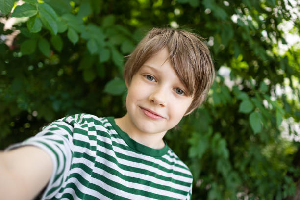 istock Young boy taking a selfie on outdoor gym 1560532235