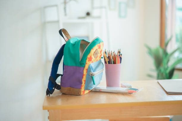 istock School backpack on wooden bench and home in the background 1560540683