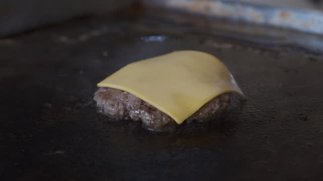 Cooking Cheeseburger on Flat Grill